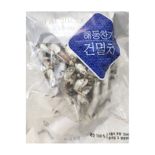 포장된 마른 멸치, 투명한 플라스틱 패키지 안에 담겨 있는 건조 멸치, 한국어로 푸른색 스티커에 '해동찬가 건멸치'이라고 적혀 있음