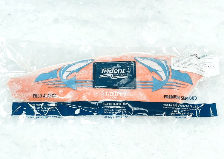 Premium wild-caught 'Copper River' king salmon fillet in a Trident Seafoods package, highlighting the detailed labeling and thawing instructions to ensure optimal freshness and taste