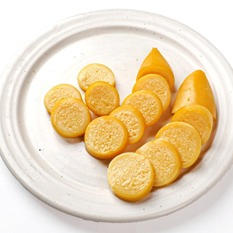 Close-up of sliced Goremi Komochi Yari-Ika on a white plate, showcasing the texture and herring roe inside the squid