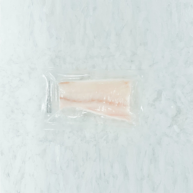 Frozen halibut tail portion vacuum-sealed in plastic packaging, ready for sale