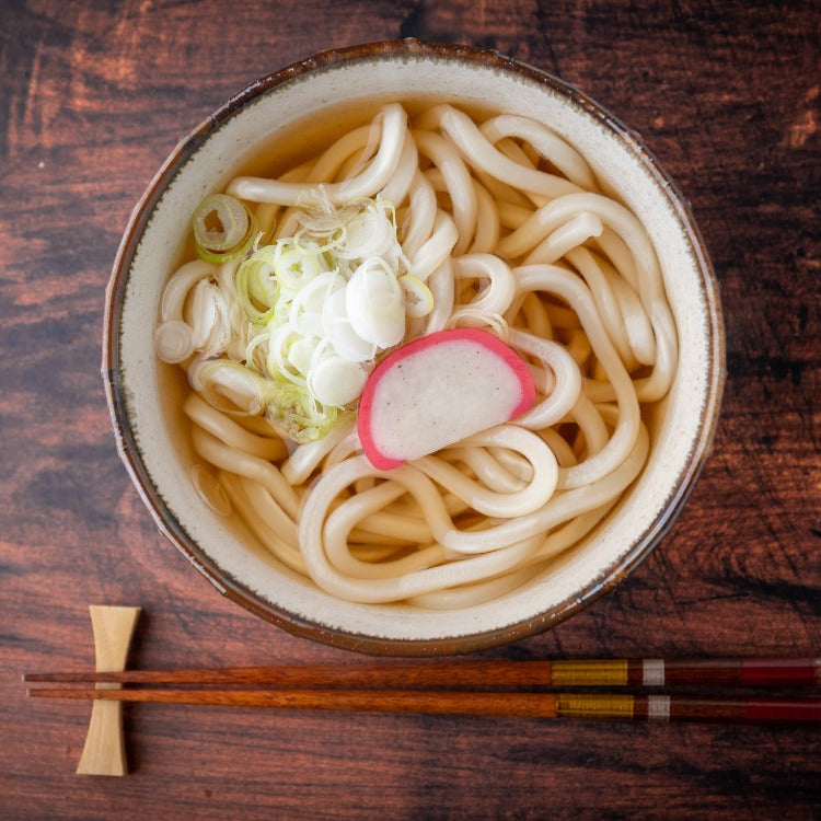 Bowl of udon topped with kamaboko fish cake slice