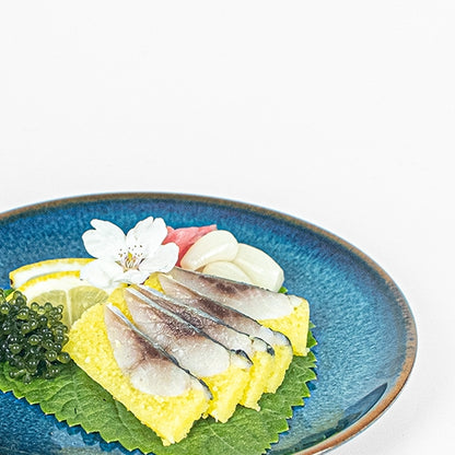 Kazunoko Nishin herring roe fillets served with garnishes on a blue plate