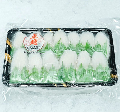 Another package of cuttlefish fillet, this time by Taku Etsu, showcasing fillets neatly arranged in a black tray, each piece separated by green faux grass, labeled as a product of Japan, also kept frozen