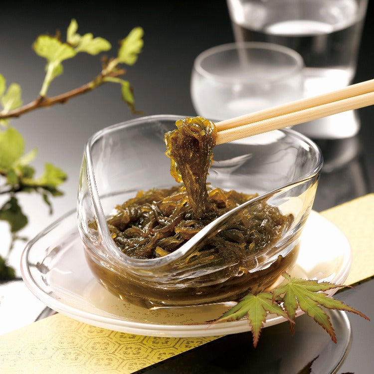 Seaweed-Chura Umi Mozuku served in a clear dish with wooden chopsticks