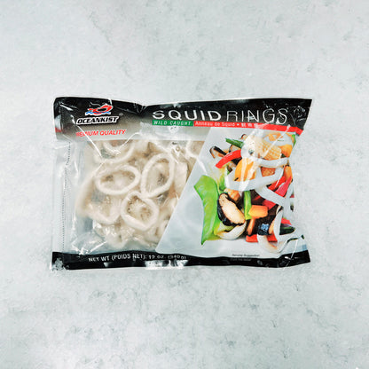 Front view of OceanKist Squid Rings packaging, showing frozen wild-caught squid rings and a serving suggestion with vegetables, 12 oz (340 g) bag