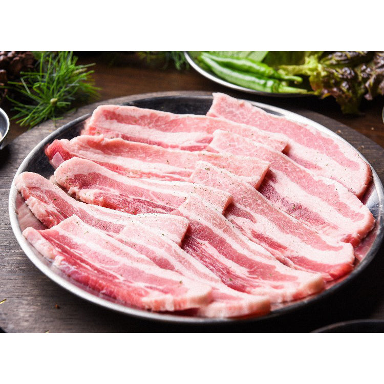 Thinly sliced raw pork belly arranged neatly on a dark ceramic plate, seasoned lightly and ready for cooking. Ideal for Korean BBQ or hotpot recipes