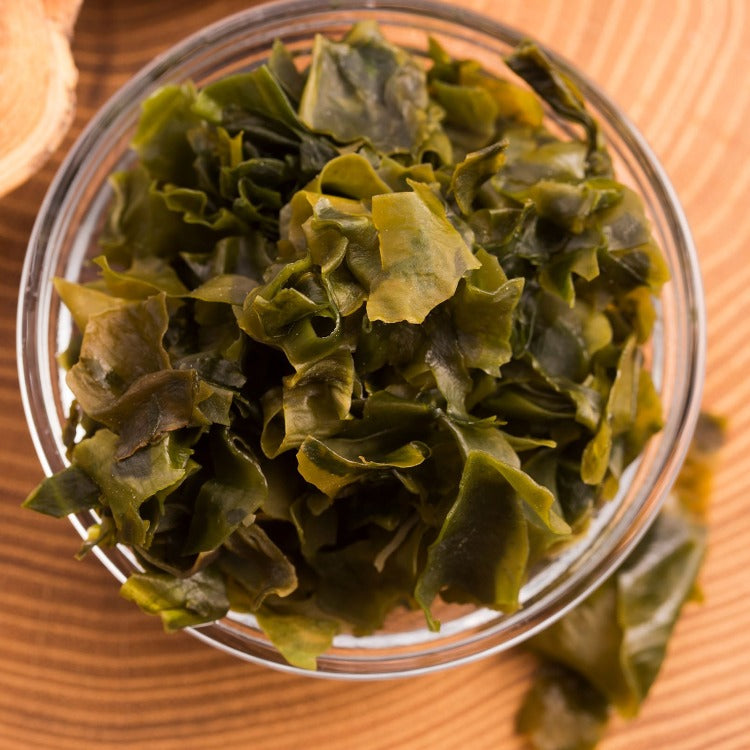 Seaweed-filled bowl on rustic table